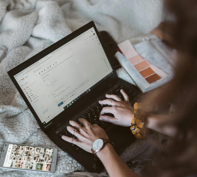 browsing emails on laptop and phone